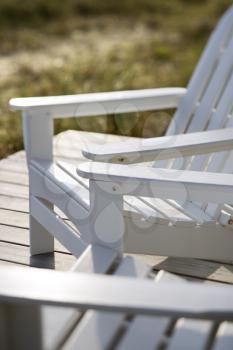 Royalty Free Photo of a Close-up of Adirondack Chairs on a Deck
