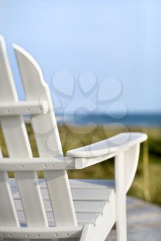 Royalty Free Photo of Adirondack Chairs on a Deck Looking Towards the Beach on Bald Head Island, North Carolina
