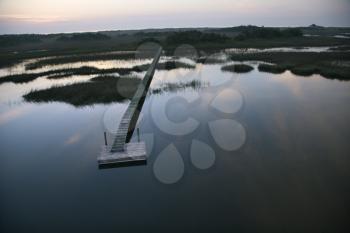 Royalty Free Photo of an Aerial View of a Boat Dock and Walkway Over a Marsh at Bald Head Island, North Carolina