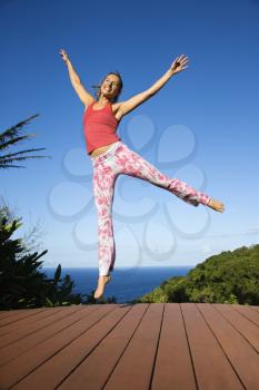 Royalty Free Photo of a Woman Jumping into the Air