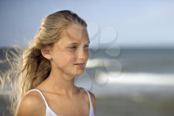 Royalty Free Photo of a Preteen Girl on a Beach With Ocean Waves in the Background