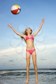 Royalty Free Photo of a Preteen Girl Playing With a Beach Ball on a Beach