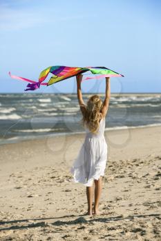 Royalty Free Photo of a Girl Holding a Kite on the Beach