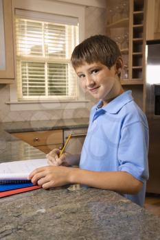 Royalty Free Photo of a Pre-Teen Boy Doing His Homework