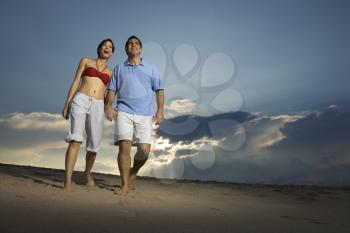 Royalty Free Photo of a Couple Holding Hands Walking on the Beach