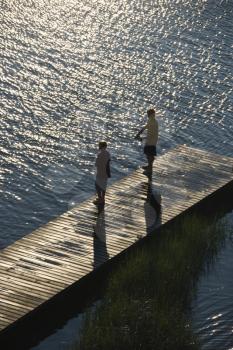 Royalty Free Photo of Two Teenage Boys Fishing From a Dock at Bald Head Island, North Carolina
