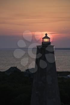 Royalty Free Photo of a Lighthouse at Sunset on Bald Head Island, North Carolina
