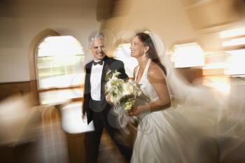Royalty Free Photo of a Bride and Groom Leaving the Church With a Motion Blur Effect