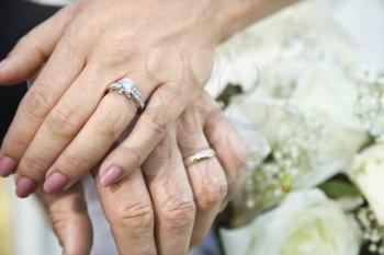 Royalty Free Photo of a Close-up of a Bride and Groom's Hands Overlapping