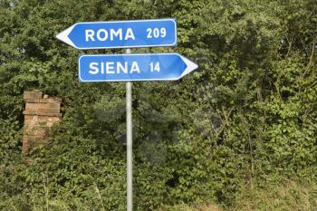 Royalty Free Photo of Italian Street Signs Pointing to Rome and Siena