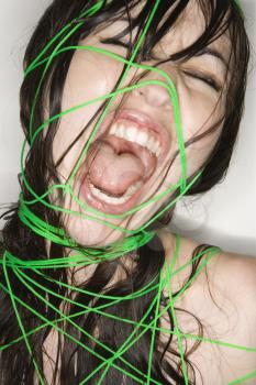 Royalty Free Photo of a Nude Young Woman Wrapped in String Screaming