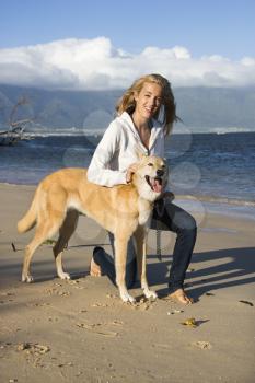 Royalty Free Photo of a Woman With a Dog on a Leash on Maui, Hawaii Beach