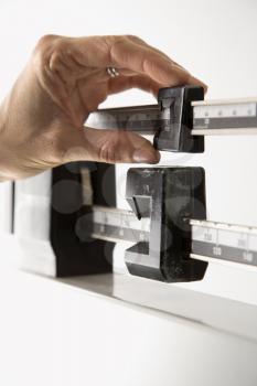 Royalty Free Photo of a Female's Hand Reading Her Weight on a Scale