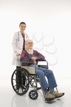 Royalty Free Photo of a Female Doctor Pushing an Elderly Male Wearing a Neck Brace in a Wheelchair