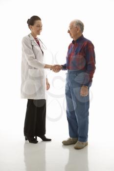 Royalty Free Photo of a Doctor Shaking Hands With an Older Man
