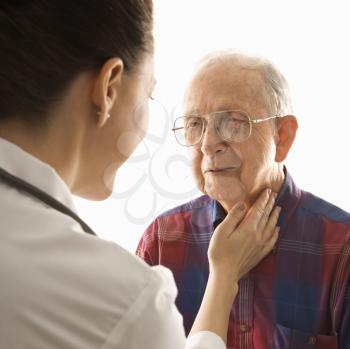 Royalty Free Photo of a Doctor Checking an Elderly Man's Pulse 