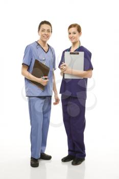 Royalty Free Photo of Female Doctors in Medical Scrubs Holding Medical Charts