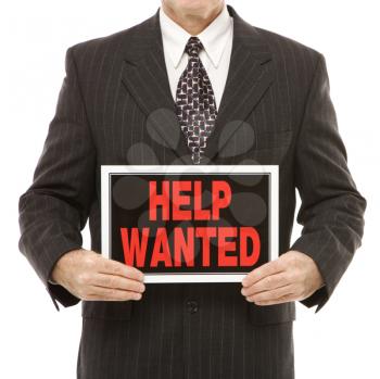 Royalty Free Photo of a Businessman Holding a Help Wanted Sign