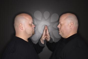 Royalty Free Photo of Bald Identical Twin Men Standing With Hands Touching