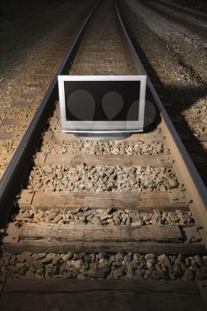 Royalty Free Photo of a Flat Panel Television Set on Railroad Tracks at Night