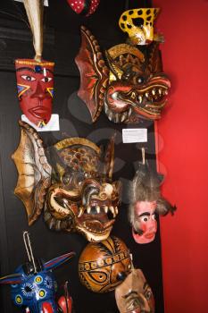 Royalty Free Photo of Folk Art Masks Hanging in a Retail Store