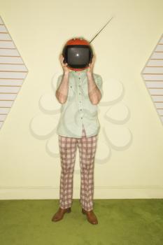 Royalty Free Photo of a Man Wearing Vintage Clothing Holding a Round Red Retro Television in Place of a Head