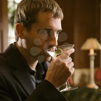 Royalty Free Photo of a Man Drinking a Martini