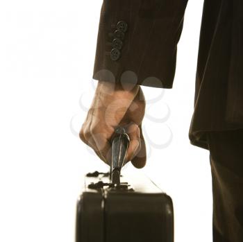 Royalty Free Photo of a Businessman in a Suit Holding a Briefcase