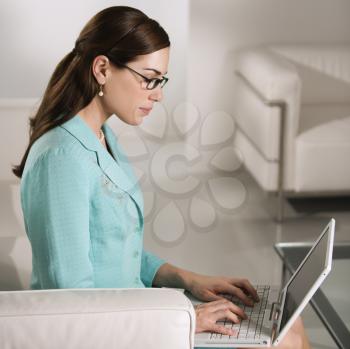 Royalty Free Photo of a Businesswoman Typing on a Laptop