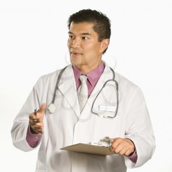 Royalty Free Photo of a Male Doctor Holding a Clipboard Talking and Gesturing