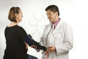 Royalty Free Photo of a Doctor Testing the Blood Pressure of Pregnant Woman