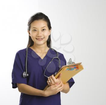 Royalty Free Photo of a Doctor Smiling and Holding Files 