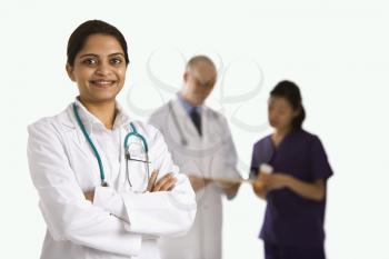 Royalty Free Photo of an Indian Woman Doctor Standing With Medical Staff in the Background