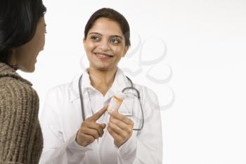 Royalty Free Photo of a Doctor Explaining Medication to a Female Patient
