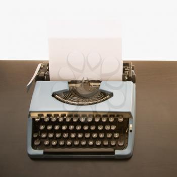 Royalty Free Photo of a Blank Sheet of Paper in an Old Fashioned Typewriter
