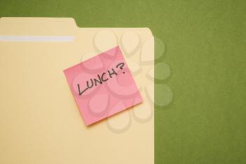 Royalty Free Photo of a Folder With a Pink Sticky Note Reading Lunch