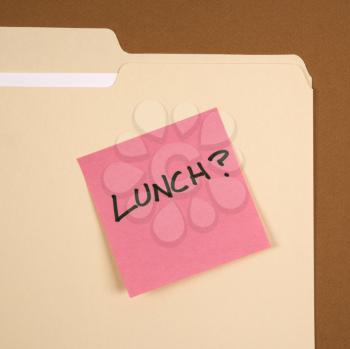 Royalty Free Photo of a Folder With a Pink Sticky Note Reading Lunch