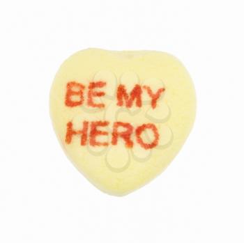 Royalty Free Photo of a Yellow Candy Heart That Reads Be My Hero