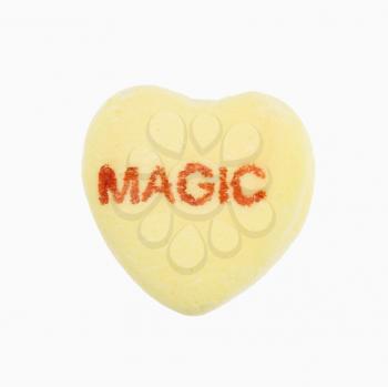 Royalty Free Photo of a Yellow Candy Heart That Reads Magic