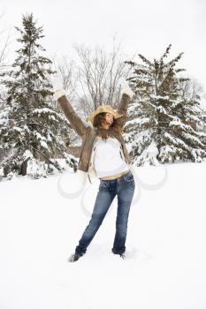 Royalty Free Photo of a Woman Standing in Snow Wearing a Straw Cowboy Hat