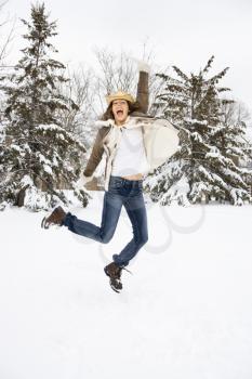 Royalty Free Photo of a Woman Jumping in the Snow