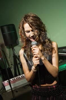 Royalty Free Photo of a Woman Singing into a Microphone