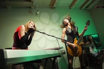 Royalty Free Photo of a Girl Band Playing Instruments