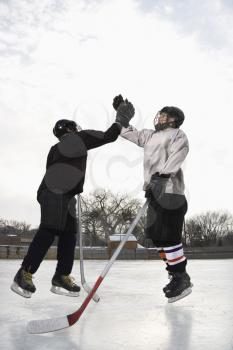 Royalty Free Photo of Hockey Players Giving a High Five