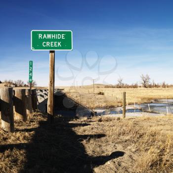 Royalty Free Photo of a Rawhide Creek Sign in a Rural Landscape