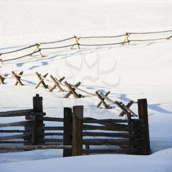 Royalty Free Photo of a Fence in a Snow Covered Landscape