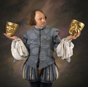 Royalty Free Photo of William Shakespeare Holding Theatrical Masks in His Hands