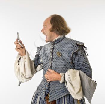 Royalty Free Photo of William Shakespeare in Period Clothing  Yelling at a Cellphone