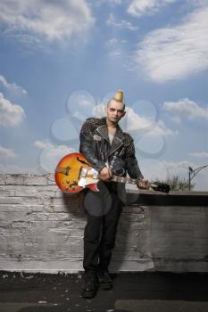 Royalty Free Photo of a Punk Holding a Guitar