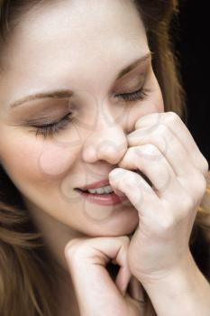 Royalty Free Photo of a Close-up Portrait of a Young Woman With Her Hand on Her Face